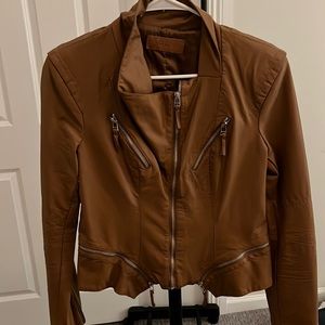 Leather jacket. Silver zipper details.